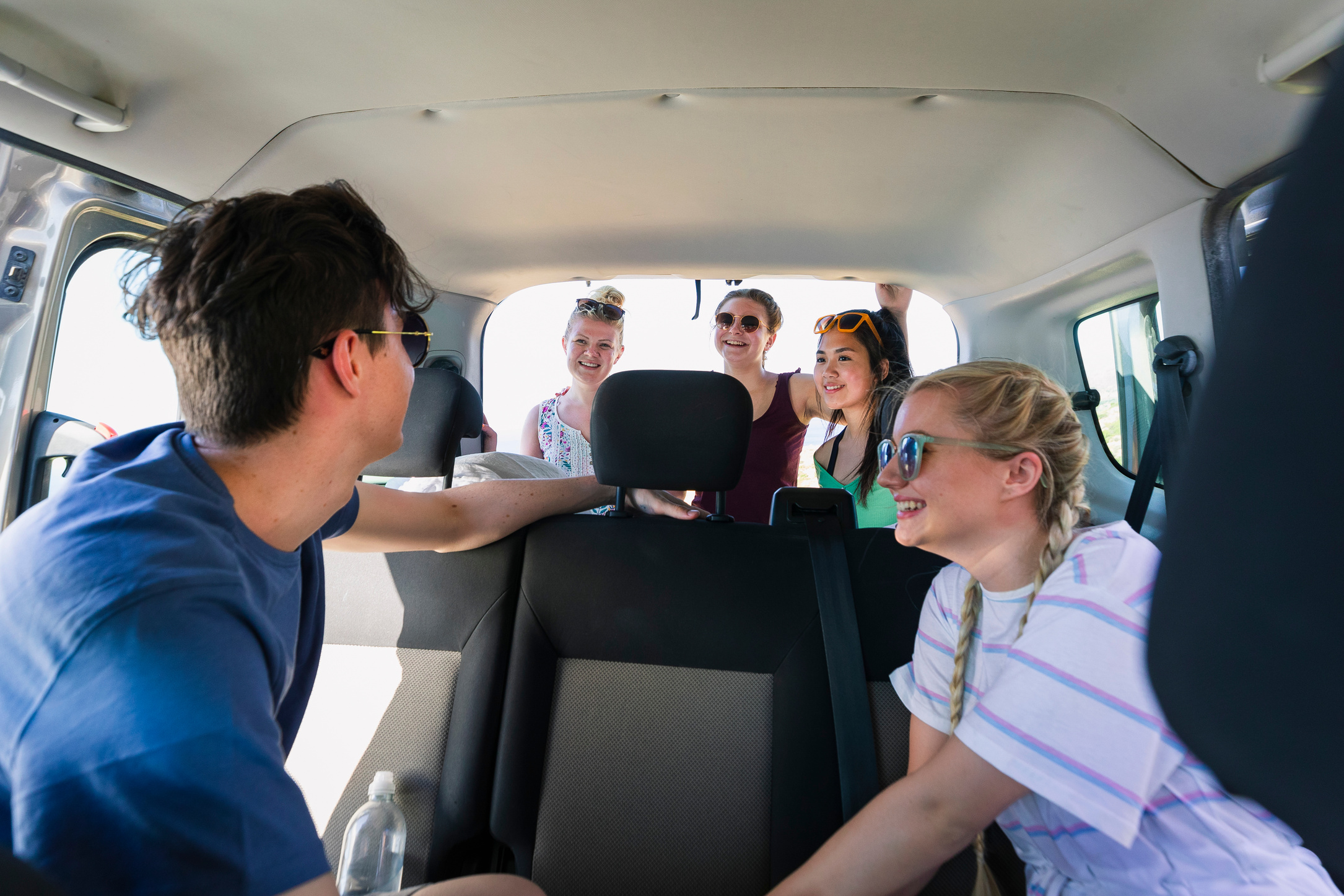 Young friends traveling in mini van on road trip